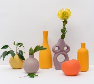photo of various sculpted vases in orange, golden yellow, and brown